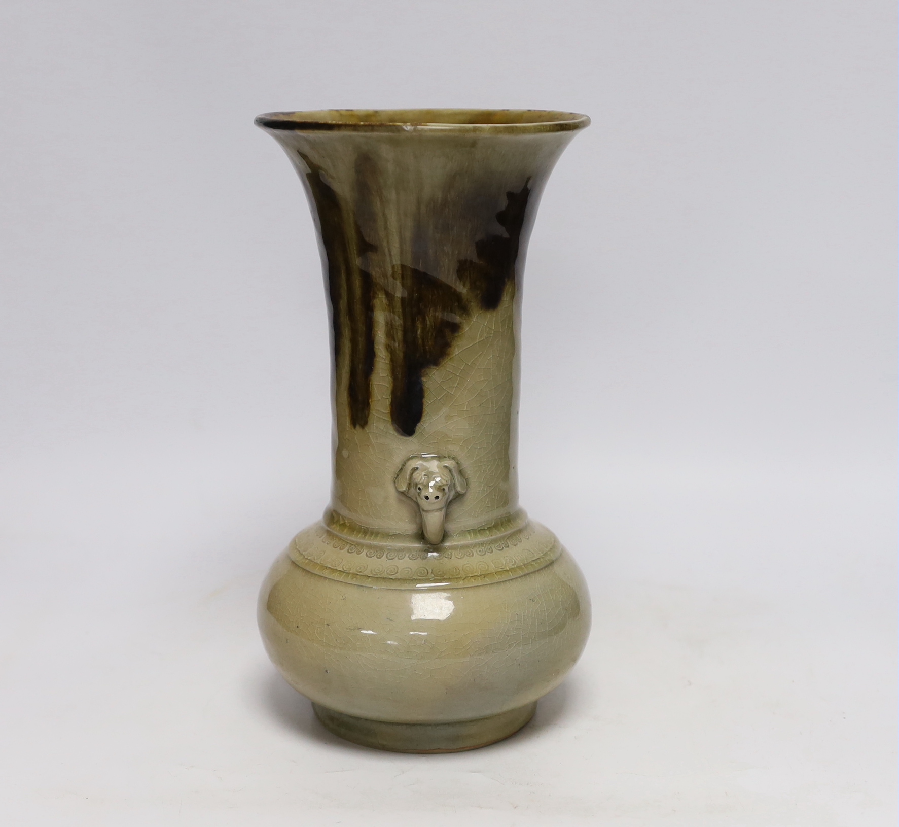 A Japanese celadon and brown glazed vase with mythical beast handles, 27cm